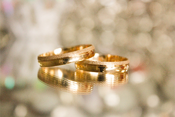 image of yellow gold wedding band set on golden background
